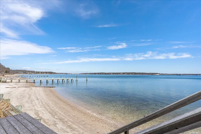 Quintessential North Fork sandy bay beachfront rental. Stunning views across Cutchogue Harbor and Peconic Bay will be yours at this spacious waterfront home, whether from the airy great room, the brick patio, or from the beachside deck. Tucked away down a quiet drive, this home offers peace and privacy in historic New Suffolk. There are 3 bedrooms and 2 baths upstairs, one bedroom and one bath downstairs, a sitting room with fireplace, full kitchen with breakfast bar, and water views from almost every room.