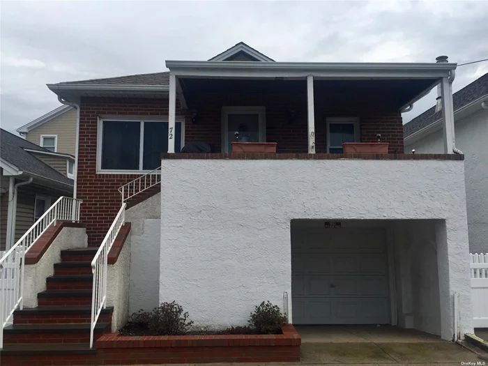 West End Wide Block High Ranch has covered front porch leading to front room with dining area, living room, kitchen, 2 bedrooms & bath. Ground level has family room w/storage closet, bedroom & full bath. Washer/dryer. Garage. Central Air.