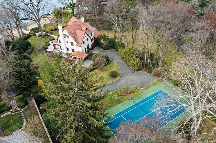 Most extraordinary waterfront estate with western facing sunsets and views of NYC Skyline, your own sandy beach and dock, will take your breath away. Sited on 2.6 exquisite acres with expansive gardens, nearly 6000sf Main house,  Gatehouse, tennis court and more. 12 Hicks Lane is beautifully updated with so many extras and offers an unparalleled luxurious and elevated lifestyle.