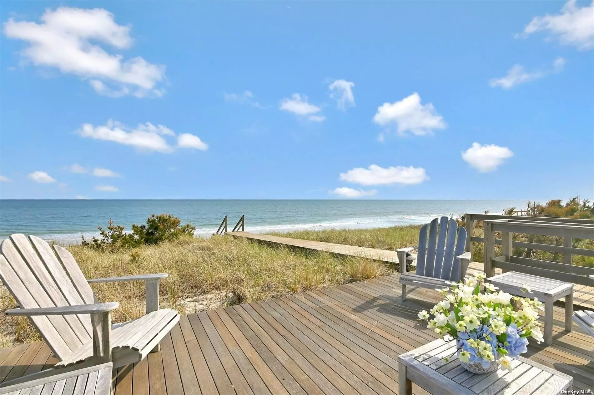 Live in laid back luxury in this oceanfront home in Quogue, one of the most desirable areas of the world famous Hamptons. On 2 acres with 127 feet of shoreline and a pre-existing non-conforming beach deck. A beautiful home, with all the amenities one could want. Five beautiful ensuite guest bedrooms, an awesome master bedroom and bath, an office, two half baths, a living room, formal dining room, spectacular kitchen, a family room, billiard room, elevator, fireplaces everywhere, an enormous swimming pool area with heated gunite swimming pool, decks, whole house backup generator, gorgeous landscaping and your own access to the pristine beach. And much more. Reward yourself, buy the beach house.