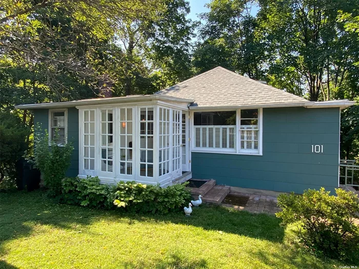 Beautifully renovated two-level craftsman style cottage/bungalow set high overlooking Central Park. A quaint and enclosed sun lit porch with sitting area serves as your entry way, welcoming you into the upper level living room complete with vaulted ceilings skylights. This space flows into two bedrooms, full bath and laundry area--all finished with modern craftsman touches. The lower level of the home reveals an inviting and spacious family room with large windows overlooking woodsy views. This open concept space features a full kitchen, dining area, living room, and full bath. Enjoy the hideaway vibes as you relax and dine outside in the beautiful patio area.