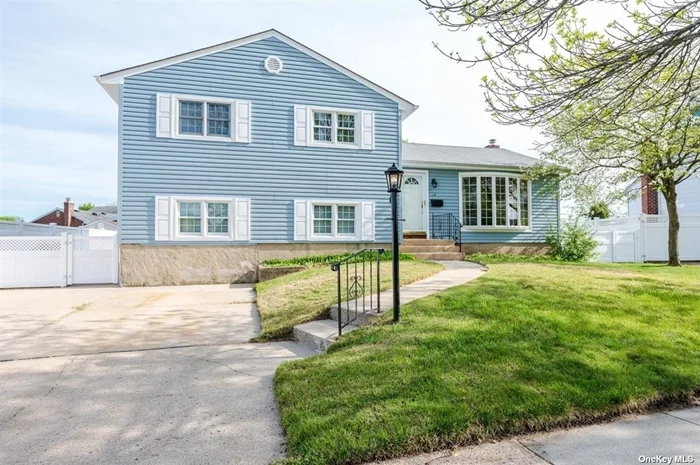 Beautifully Situated Split Level Home Features Gleaming Hardwood Floors Throughout - Custom Oversized Anderson Window in LR Overlooks Top of the Block Vista That is Truly Unique. Ground Level Family Room Adjacent to Converted Garage That Provides Even More Space. Additional Second Full Bath on This Level Along with Extra Large Mud Room or Utility Room- Main Level Eat in Kitchen Recently Updated That is Ample Sized for Table and Flows into Your Formal Dining Room with Large Sliders Lead that to Huge Deck in Your Oversized Private Yard. Large Full Basement with New Gas Burner and Separate Solar Hot Water Heater-10 Year Young Roof-Walk to Park and High School. All Large Rooms- Taxes Do Reflect Additional STAR Savings of $1213 - Make This Your Forever Home!