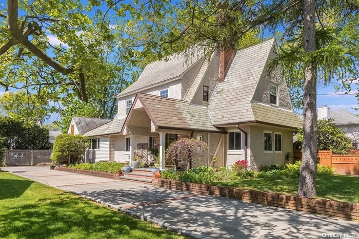 One of the original 12 houses built in The Estates section! Tudor Colonial built-in 1926 offers an excellent location with 1, 671 interior sq ft on oversized 96X100 lot with lots of character inside/out. 4 BR 2.5 Baths foyer LR w/fireplace open FDR, Family Room extension w/skylight, EIK access decks (granite, stainless steel appliances, cherry wood cabinets gray subway tile backsplash) plus front enclosed sunroom perfect for home office! Wood floors throughout including the 3rd floor, 150 amp electric service, 2 car detached garage with full depth driveway makes spacious workshop. Double whole house water filter, central Vac, wood fenced yard with a secret garden, native garden gorgeous flowers, Koi pond...much more. Washer Gas Dryer and excellent storage in the unfinished basement. No flood insurance required.