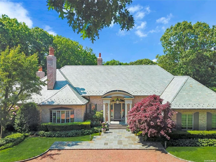 Exquisite in architectural detail & design, this grand 7, 000+ sf brick and slate-roofed manor home reflects modern sophistication & timeless elegance. Set back on a quiet drive, this serene oasis showcases expansive outdoor terraced entertainment space overlooking 5+ park-like acres! A spa w/wterfall, 50&rsquo; heated pool & lush specimen plantings further enhance this luxury retreat. Past a gracious entry awaits stunning interiors, elegant DR w/FP & herringbone oak floor, grand LR w/FP & high ceilings, media rm, custom chef&rsquo;s kitchen w/FP, butler&rsquo;s pantry & sunny breakfast area lead to outdoor dining w/built-in BBQ. Inviting Primary suite w/FP, adjoining office, lg custom WI closets, & spa-like bath w/2 WCs. Main floor continues w/exec. office/BR w/bath, 2 BRs w/J&J bath, add&rsquo;l BR w/bath. Stairway leads to a 2-rm BR suite. Fabulous 5000sf.LL w/guest suite, gym, bar, office, 3 full baths and entertainment spaces open to the pool/spa & pergola. Tranquility in the heart of LI&rsquo;s North Shore!