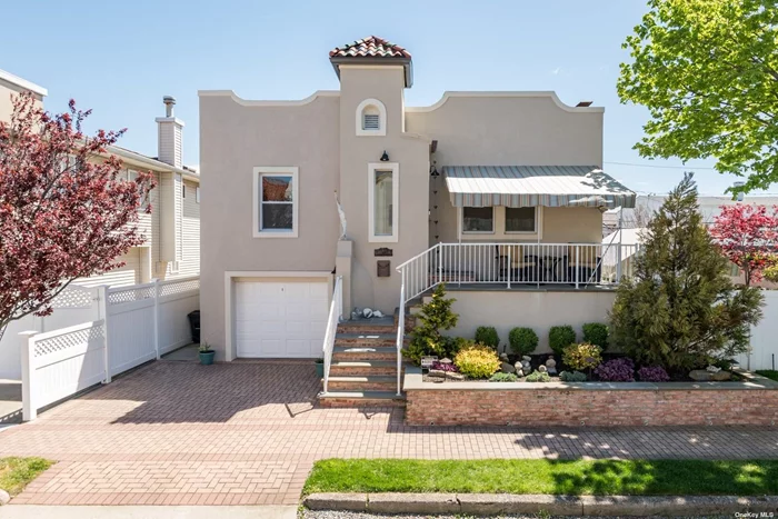 Picturesque Sand-Tone Stucco Seaside Escape on Treelined President Streets of Long Beach. Immaculate Meticulously Maintained 4 Bedroom, 3 Full Bath Mediterranean. Relaxing Covered Front Porch. Naturally Lit Open Floor Plan. Ornate Original Hardwood Flooring. Reminiscent Elegant Moldings & DR Built-In Cabinetry. Elegant Updated Kitchen, Granite Countertops & SS Appliances. Sun-filled Master Bedroom Suite. Two Additional Charming Bedrooms Upstairs with Beautiful Full Bath. Ground Floor Lower Level Spacious Den/Living Space with Stunning New Full Bath, Bedroom & Separate Entrance. Lower Level Leads Private Peaceful Landscaped Oasis. Elegant Pavers & Covered Built-in Awning Enveloped by Lush Grass & Graceful Landscaping Unobstructed from Natural Light. Inviting Out Door Shower. Two Private Driveways & Garage Parking.(Upgrades: 2021 New Windows, Alarm System, Upgraded Steam Heat. 2020 New Roof. 2019 New Stucco, Front Porch & Steps, Outdoor Shower & W/D. 2018 New Kit Appl & HW Heater).