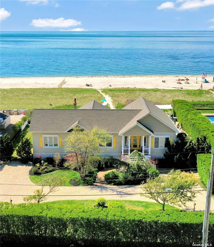 Experience the luxury of a new lifestyle of breathtaking views from sunrise to sunset on your exclusive, private sandy beach and home on LI Sound. A rare, hidden treasure on the North Fork with an accreting beach and 100 ft of waterfront property. Soak up the sun & relaxing sea breezes, picnic, boat, kayak and end the day sitting by a cozy bonfire all just steps away from your own back door. This home boasts an extraordinary, flexible layout. The main level welcomes you with a living room, and entertainment area, looking down to the Sound, an office/den and has an expansive master bdrm w/private bath & deck. On the beach level there is another living room, kitchen, second master bdrm, and guest en-suite. In total the home has 4 bedrooms and 4.5 baths, an eat-in kitchen, plenty of room for entertaining including a wet bar with built in custom cabinets & wine cooler. Surrounded by gardens and lined w/privets for privacy, this home offers a pristine setting for the most selective buyers.