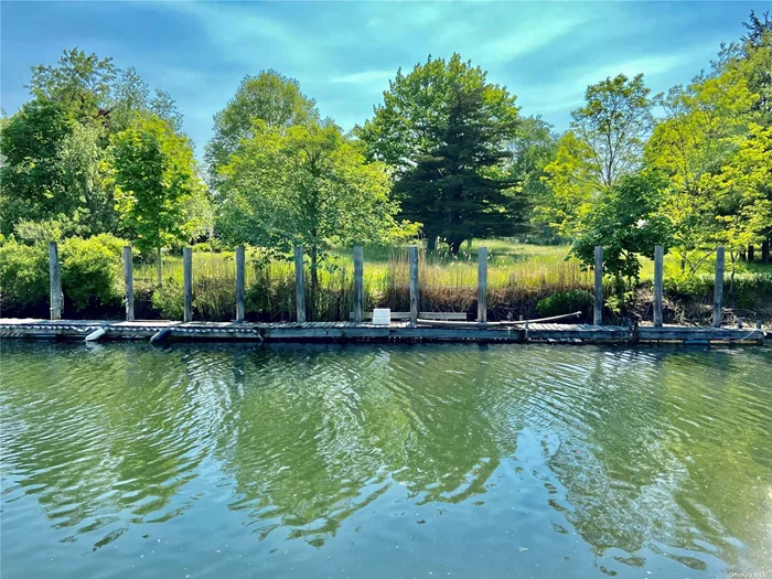 Nautical level waterfront lot located central to Greenport Village and Klipp Park and Beach. This property offers boaters haven in a protected location on Sterling Harbor. Envision building your dream home and keep your boat in the back yard.