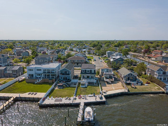 Gorgeous & Spacious Bay Front Colonial- You&rsquo;ll Never Want To Leave Home. 4 Bedrooms, 2.5 Baths. 9 Ft. Ceilings, Hardwood Floors. Pristine Eat-In-Kitchen & Grand Living Room W/ Sparkling Views of the Bay. Boat lift, Mooring Poles and 50ft Pier. 12, 000 lb lift Hold up to 26 Ft. Boat, 9.6ft Beam