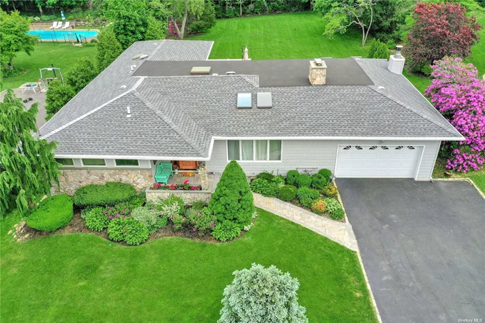 North Syosset Expanded ranch on a flat 1/2 acre! Large master suite with a new master bath, open floor plan with a sunlit living room, open kitchen, cozy den with gas fireplace. CAC, IGS,  updated Gas burner. Roof under 5 years old. Finished basement with bath. 2 car garage. Berry Hill Elementary!!