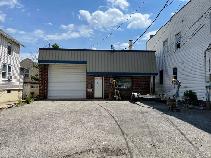 Highly visible location with easy access to main roads, LIRR, town, schools, this cavernous warehouse on local through street is zoned IB. It features a 2200sf concrete block building with dividing wall, a rear office mezzanine of 656sf plus two bathrooms in front. New roof, 2020. Parking on site plus metered street parking.