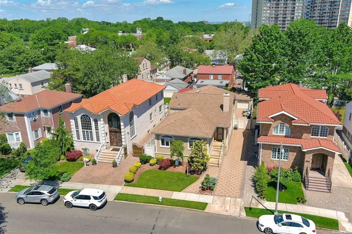 Welcome to this Picturesque 10 Room Split Level Home on an over sized manicured property. Located in North Bayside, this home offers Southern Exposure & a versatile floor plan which allow for easy living. Sun drench Living room with high ceilings, Tuscan Style Eat-In Kitchen with Silstone Counter Tops, Italian Porcelain Sink, Stone Tile Back Splash & large Italian tile flooring. Custom renovated bathrooms throughout, including guest bathroom with 18 Carat Gold Plated Fixtures & spacious bedrooms with exceptionable closet space throughout this home. The lower Level features a family room, bedroom, powder room, and sunroom with radiant heated floors that leads to a park-like private yard, great for entertaining & room for a inground pool. Rear full extension on home, finished basement, one car garage + private driveway, many upgrades, Video Camera System, 200 Amp Electrical Service, 6 zone gas heating & 2 zone CAC. Rare opportunity worth owning.