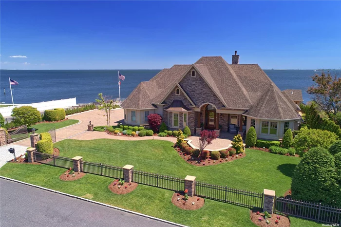 Watch the fireworks from this spectacular waterfront Oak Neck Estate residence. Newly constructed open layout with the finest millwork and craftsmanship throughout. Formal living room with romantic fireplace, dining room, temperature controlled wine room, eat-in-kitchen with easy access to the private yard, pool and outdoor kitchen. Primary en suite is conveniently located on the 1st floor with water views, fireplace and a separate en suite lounge. Additional bedrooms on the 2nd floor, each having their own balcony and bath. Ample storage with possible room expansion. Enjoy the private outdoors within this residence, host a pool party, pull up your boat on your very own dock, or simply enjoy a glass of wine on your balcony as you take in the sunsets.