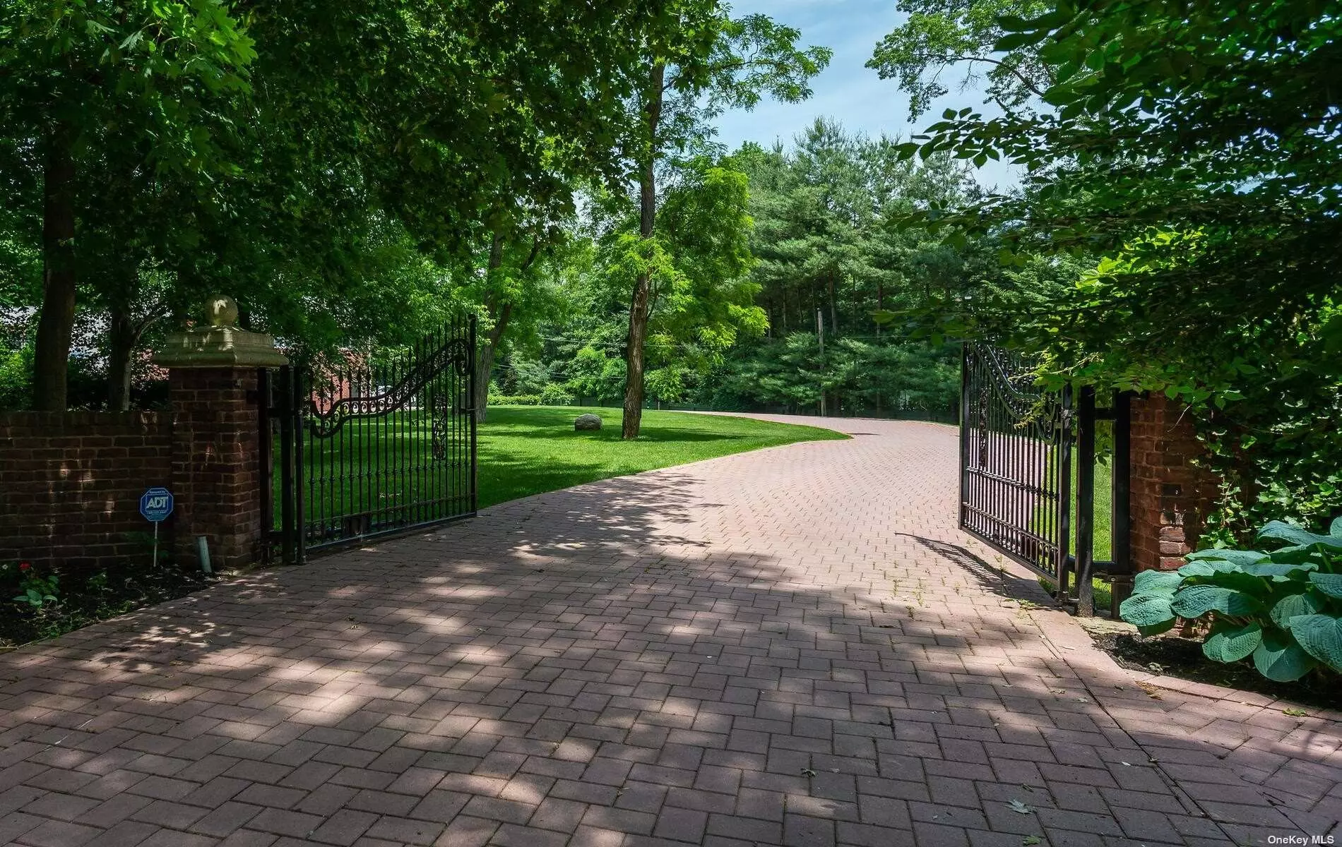 This 6 bed/5 bath expanded Center Hall Colonial style residence sits on over 2 acres of well groomed flat land while offering convenience, privacy, and comfortable living. A set of grand iron gates reveals gorgeous red brick pavement. Skylights throughout the house allow for excellent natural lighting to accentuate the open concept floor plan and the multiple master suites (one on each floor). The lower level, complete with an outside entrance, is versatile and has room for entertainment, exercise, and storage. The second floor patio is spacious and overlooks the verdant landscaping, the heated vinyl in-ground pool, and the outdoor hot tub. The 4 car garage rounds out this one of a kind home.