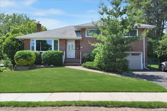 This midcentury brick split-level ranch is available for the first time in over 45 years. This rare find has extremely low taxes and a smart layout that allows for more separation between floors. On the main level find nearly 30 feet of living and dining with two large bay windows that flood the home with natural light, recessed lighting, hard wood floors and windowed kitchen. Upstairs find a gracious master bd. with en-suite bth , two spacious bds. and shared XL bth. Downstairs is great for those who want to have a family room, office, gym, or walk-out den with separate entrance. There is att. garage and hobby space with engineered hard wood floors, shelving, and track lighting. The home is equipped with central A/C, automated blinds, newer windows, and plenty of storage in the basement. This wide corner lot has curb appeal with beautiful landscaping, double wide driveway, and room to play in terms of yard space. Located on a quiet, leafy street near the sought-after Syosset schools,