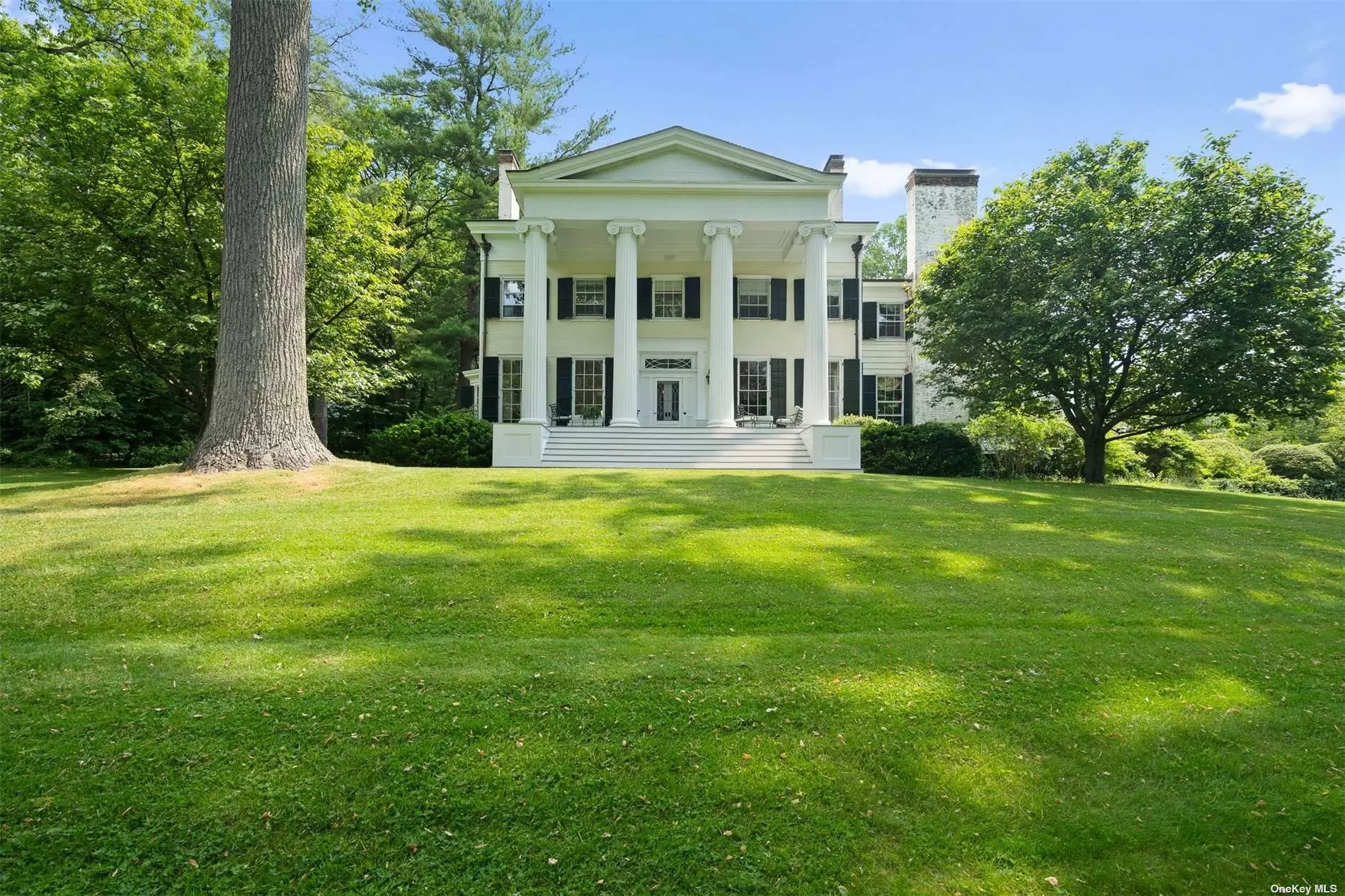 Originally built by the Youngs family as a working farm, this 5-Acre Estate has been meticulously restored by the current owners to preserve its heritage and maintain the integrity. Once owned by the son of Louis Comfort Tiffany, this 7 Bedroom Greek Revival residence has magical gardens, saltwater Pool and Pool House, Greenhouse, 2-Bedroom Cottage, Recreation Barn, Generator and Brick Coach House Garage. Surrounded by 21 Acres of conserved land, Elmwood is a rare offering. Original details include 14 ft. ceilings on 1st floor, 9 ft. on the 2nd floor, 9 fireplaces, hardwood floors, and architectural elements including elegant moldings, interior shutters, built-ins, hardware and window seats. Steeped in history, with only 4 owners, this estate embodies an idyllic lifestyle with modern updates minutes from all that the quaint village of Oyster Bay offers.
