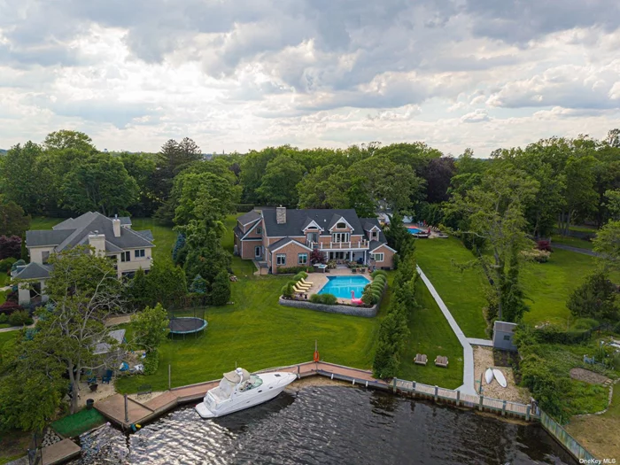 Beautiful Updated 6000 Sq. Ft Waterfront Colonial Set On Just Over An Acre With 3 Car Garage. Updated EIK w/Breakfast Nook, Den, FDR w/FPL, Great Room, Master Suite Plus 4 Family Brs, 3.5 Baths. Entertainers Backyard w/Bulkhead, IGP, Paver Patio, Covered Dining Area, Stone Outdoor Fireplace.
