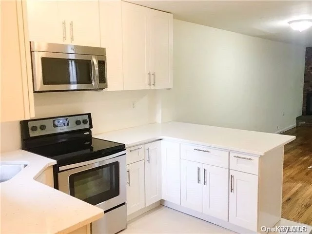 Beautiful 2x2.5 Townhouse w/3 Floors Of Space! Hardwood Floors & Open Floor Plan - Updated Kitchen/Dining/Living Room w/Fireplace & Sliders To Cozy, Private Deck + Half Bath On First Floor. Upstairs Has High Ceilings, HW Floors, Master Suite/Bath w/Walk-In Closet, Additional Spacious BR w/Full Bath, Basement w/Laundry + Storage/Garage & Driveway, Near Beach, Pool, Park, Tennis, Shopping, Dining, Marinas & Bus In Exclusive Orchard Beach Section Of Port Washington!