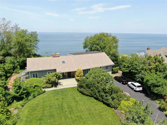 A seaside oasis. This gorgeous home has breath taking views of Long Island Sound . Plenty of windows throughout engulf the home in natural light & showcase the beautiful views. Vaulted, wood beamed ceilings, a floor to ceiling brick fireplace & large archways in the living room give the home a grand feel. The large eat-in-kitchen has a continuation of the beamed ceilings, dark wood cabinets, Iron stone flooring, & SS appliances providing a Mediterranean feel. Leading from the living space to the rear deck is an expansive IG Pool & beach rights. Wake up to a beautiful view in your spacious master bedroom featuring two WIKs & private en-suite. This home has a second story guests quarters or home office complete with a living room, kitchen, bedroom and bath allows you to keep your guests close while both enjoying your privacy. Private beach rights stairs border the property to the west. New in 2020 sea bulkhead with stone armoring, bluff is fully intact securing this home for many years.