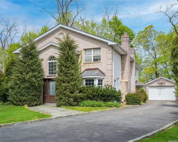 3400 Sq.Ft. Colonial set back on over a 1/2 acre on treelined street with an abundance of amenities nearby. Situated only 1mi to Glen Cove & Sea Cliff Villages, 1/2mi to train station, 2mi to Morgan Park with beach/playground/concerts, minutes to Pryibil Beach (Glen Cove residents only), golf courses, marinas, parks, schools, & more. Two-story foyer leads to a sun-filled interior with hardwood floors & crown mouldings. Living room featuring wood burning fireplace leads to dining/family rooms & eat in kitchen with gas cooking and back staircase. 2 first floor bedrooms can be used as an office or recreation space. Second floor encompasses a total of 5 bedrooms including an oversized en-suite primary bedroom with walk-in closet & cathedral ceilings, plus convenient laundry room. Full attic & detached 1.5 car garage with long driveway for ample parking. Step outside from kitchen or family room onto brick patio with built in BBQ overlooking sprawling backyard with plenty room for a pool.