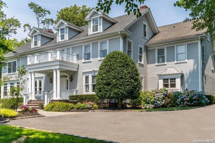 Gracious 1912 Federal Style Colonial fully renovated and rebuilt with beautiful architectural details on 1.3 Acres. This pristine home has so much to offer- Elegant Living room with gas fireplace and Dining room with Wood Burning Fireplace, two powder rooms, handsome wood paneled Library, and sophisticated Sun Room with French doors leading out to the blue stone terrace- Perfect for entertaining. Over sized Eat-In-Kitchen with custom cabinetry, marble countertops, premium appliances opening into a large family room. Upstairs the primary suite has a wood burning fireplace, luxurious bath with shower, soaking tub and a large walk in closet. There are 4 additional bedrooms, a home office and 2 additional full baths. A third floor finished with two bonus rooms and extra storage completes this special home. The property is set back from Duck Pond Road and features lush greenery, specimen trees and a private gated entrance.