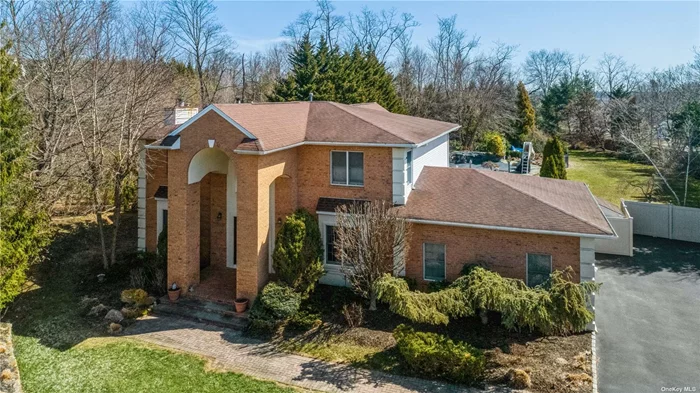 Majestically Perched at the Head of a Prestigious Muttontown Cul-de-Sac Sits This Architectural Gem.You Will Be Greeted by an Impressive Grand Brick Portico, Opulent, Yet Welcoming. A Sunny Two Story Entrance Foyer is The Focal Point of the Home, Branching Into Large Principle Rooms Ornate with Exquisite Crown Moldings and Rich Wood Flooring. A Large Living Room With Fireplace, An Inviting Formal Dining Room and Generous Sized Family Room, With a Second Fireplace, Are Perfect Spaces for Entertaining. The Kitchen Includes an Island With Granite-Topped Cabinetry and French Doors That Lead to an All-Glass Circular Sunroom That Brings the Outdoors In During Every Season. A Sweeping Romantic Staircase Brings You to the Second Floor Private Rooms, A Palatial Master Suite, Three Family Bedrooms and a Full Bath.The Basement is Full and Finished and Offers a Full Wine Cellar with an Exquisite Wine Tasting Room. A Country Club Backyard Complete With Gunite Pool and Spa Awaits You.