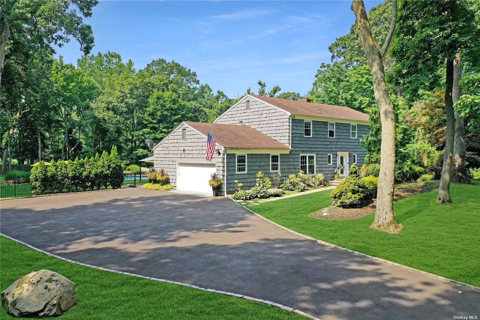 Privacy prevails in this magnificently renovated & tastefully designed Colonial, ideally located on 2 lushly landscaped acres. Enter through a sun-lit foyer into a fabulous main level open floor plan w/4 bedrooms, 2 full baths & 2 half baths. Beautiful 5in. plank hardwood floors & custom millwork throughout. European eat-in chef&rsquo;s kitchen was designed for entertaining & everyday living. Featuring granite countertops, spacious ctr island w/built-in microwave & storage, top-of-the-line ss appliances & a sun-filled breakfast area overlooking sumptuous gardens. The spacious family room with fireplace is the perfect space for entertaining or relaxing, while the living room w/ fireplace leads you to a huge screened-in porch with elevated views of the country club yard & in-ground heated gunite saltwater pool. The spacious paver patios, firepit, & outdoor kitchen give the perfect atmosphere! Close to NYC, golf, shopping, dining, & more! A must see! Jericho schools.