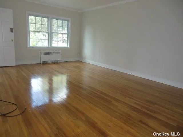 Large and bright one-bedroom apartment on the second floor. Only 5-6 min walk to LIRR Bayside stop. Near all shops, restaurants major roadways. Very nice and quiet neighborhood. Hardwood floors though-out. Extra-large living room Separated formal D/R. Master bedroom fits king size bed. Extra closet space. Heat and water are included. Plenty of street parking.