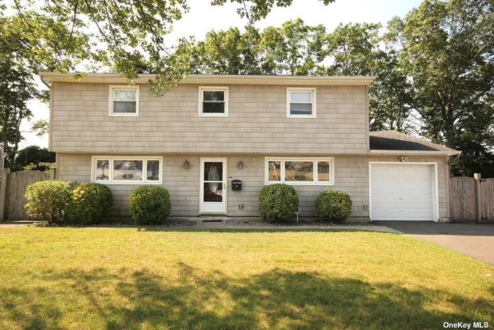 Lovely 3 or 4 Bedroom Split level Colonial Splanch features new updated Kitchen, Granite Countertops, Wood Cabinets and hardwood Floors throughout. Open Floorplan into Diningroom and Family Room with Cathedral Ceilings and Hi -Hat Lighting. First Level also has additional Den/Playroom or Bedroom, plus added bonus room with office and laundry, Full Bath with Shower Upper level has Master Bedroom, 2 Additional Bedrooms and Full Bath with Jetted Tub. Sliding Glass doors lead to Full Fenced Yard with welcoming fire pit and patio for entertaining situated on large 75x100 parcel! House has new gas heating system, 2 zones, plus CAC with additional Ductless AC. One Gar Garage, New Burner, Inground Sprinklers.