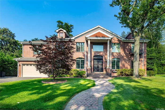 Majestic brick colonial custom-built in 2013 on tree-lined street in University Gardens. This 5-bedroom, 4.5-bath home has south west exposure and great sun. Elegant moldings, gleaming hardwood floors and exquisite finishes throughout. Enter through a 2-story foyer with dramatic bridal staircase. The main floor features an open family room adjoining a gourmet kitchen with high-end appliances and custom cabinets, dining room, spacious living room, breakfast alcove, designer powder room and 2-car garage. The upstairs bedrooms include a huge master suite with spa bath and walk-in closet and 3 additional bedrooms with 2 full baths. 2 upstairs terraces overlook the backyard. The full finished basement has spa bath and staircase to the expansive backyard with 2 patios. Ergonomic features include foam insulation and heated floors. Lakeville Elementary, Great Neck South Middle and High Schools. Steps away from private community pool, tennis courts and playground. Convenient to transportation.