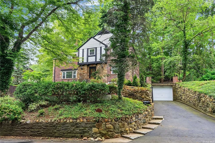 Timeless Brick And Stone Colonial In the Village of Roslyn. 3 Bedrooms, 2.5 baths with Central Air Conditioning. Bright and airy sunroom, eat-in- kitchen with updated Stainless Steel Appliances. 2 wood-burning fireplaces, renovated powder room, brand new energy efficient windows, hardwood floors throughout, oversized master bedroom with master bathroom, full finished basement with room for a home office or recreational room, laundry area, utility room. 1 car garage, bluestone deck and patio, majestic sunset views, lots of privacy, within walking distance to restaurants and shops.