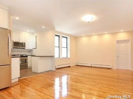 Completely updated and spacious Condo. Hardwood floors and High ceilings & Brand new windows create a city design style on the beach! 6th floor unit overlooking town with Bay and Manhattan skyline in the distance. Custom design fully functional kitchen with granite counters and open to Living area. Super close to LIRR, perfect for Commuters. Pets allowed. Parking Available for Additional $85/m. Heat Included. Laundry room on Premises. Subletting for investors. What more can you ask for!