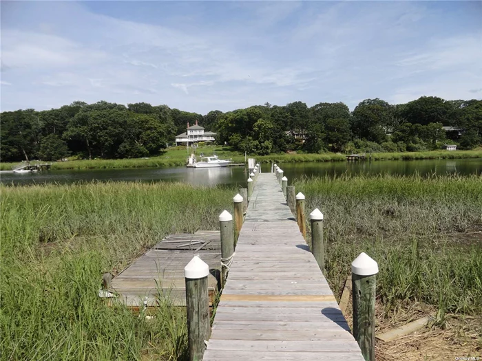 Beautiful, Private Location on Mattituck Creek! 3 Bedroom, 2 Bath Contemporary on 1.4 Ac with Detached 2 Car Garage and Dock with Electric and Water.