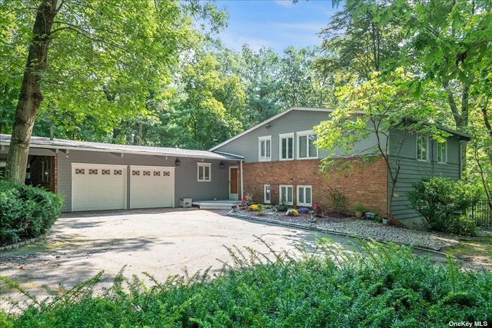 Spacious split on full, fenced-in acre in a bucolic setting. Quiet & serene but easily accessible to major roads. Floor to ceiling windows and 3 skylights bring in the serenity of the location as do the sliders to the new Trex deck Inside are custom oak floors and cabinetry,  cathedral ceilings with redwood beams from California, and a marble surround for the fireplace. Plumbing, wiring, roof & skylights have been updated in the past 2 to 3 years