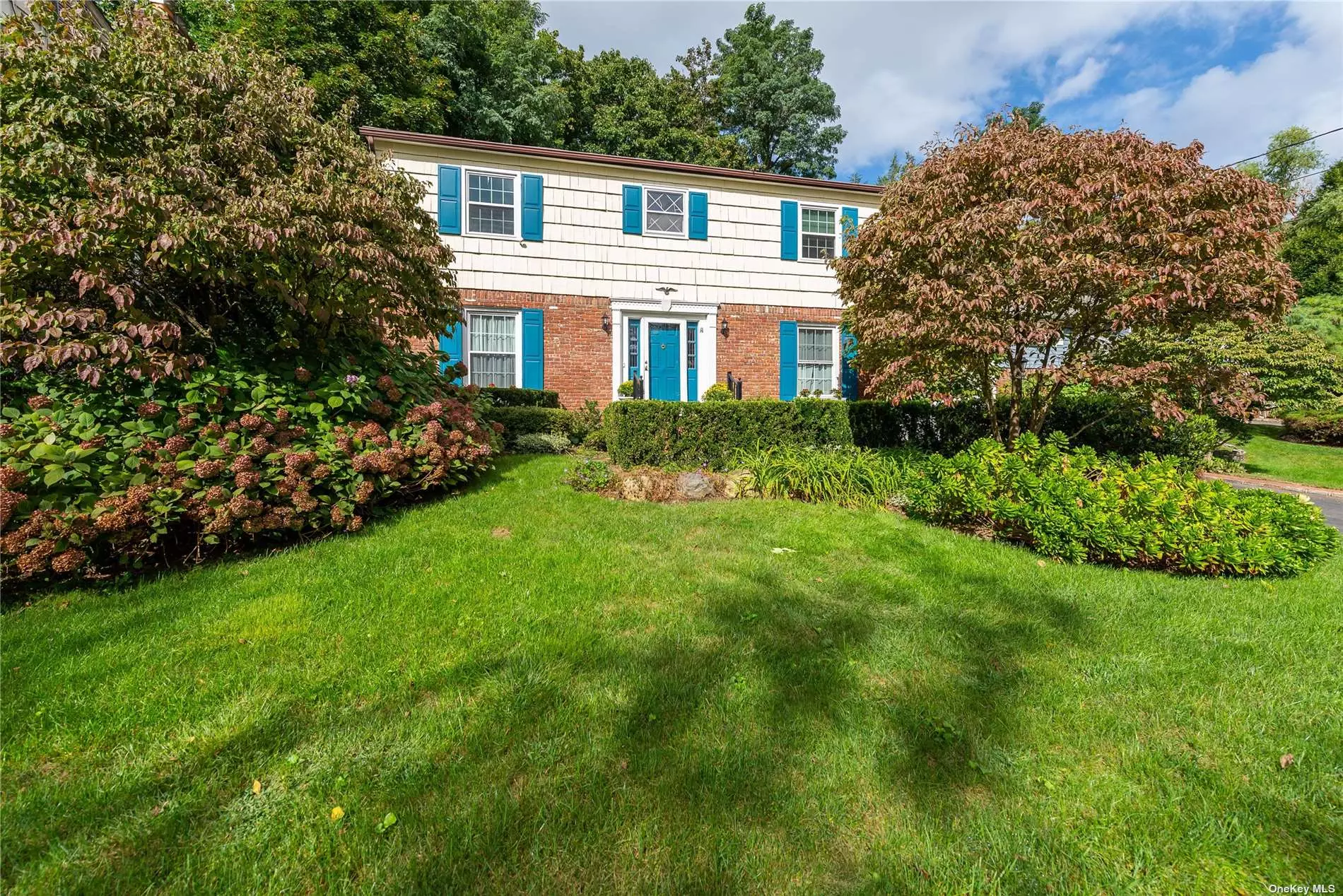 This traditional Center Hall Colonial welcomes you to a spacious foyer with an elegant circular staircase, gracious living room, formal dining room, eat-in-kitchen, adjacent family room with fireplace, laundry room, and powder room complete first floor. Spacious second floor landing with large primary bedroom and full bath, 3 additional bedrooms, and hall bath. Lush landscaping and expansive brick patio. Conveniently located close to schools and shops.