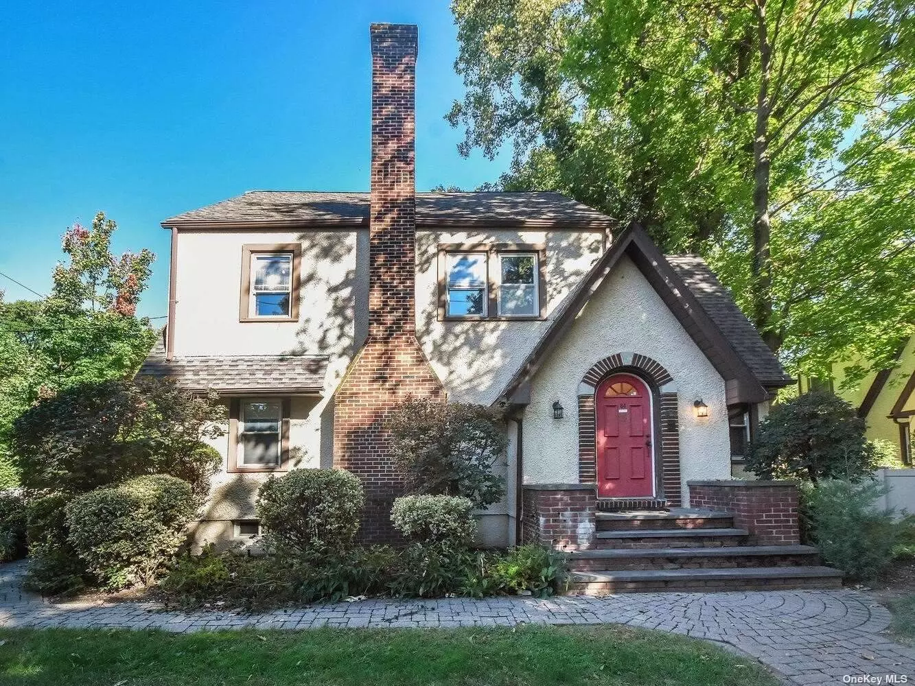 Timeless Tudor with old-world charm. This spacious 1930s three story home sits on a corner parcel on a tranquil tree-lined street on the outskirts of Sea Cliff village. Features parquet wood floors, wood-burning fireplace, separate den area, formal dining room, eat-in kitchen, three full bedrooms, one and one-half baths and a full walk-up third story attic. Detached 2-car garage and private back patio with a fully fenced-in yard. Restore this once stunning home to its former glory to embody your vision!