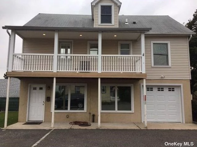 Two Bedroom Apartment on Quiet Block Nestled Behind Main House. Each Bedroom Has its Own Full Bathroom. 1 Car Garage Plus Ample Outside Parking. 1st Floor is Mostly Kitchen with Small Living Space.