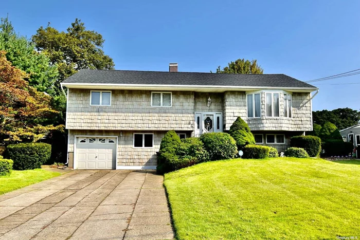 Welcome home to this beautiful 4 BR, 2 1/2 Bath Hi Ranch sitting on .25 acre of manicured land. Several features of this house include an updated roof, new gutters, soffits/ facia boards, composite deck w/ vinyl railings all replaced 2 years ago. Also included large driveway w/ 1 car att garage (laundry room), cement patio, large shed, central air/heat, HW floors under carpet on 2nd floor and the master BR has a half bath. And with proper permits the 1st floor is set up as a separate apartment with a private entry 1 BR, full bath, LR and EIK.