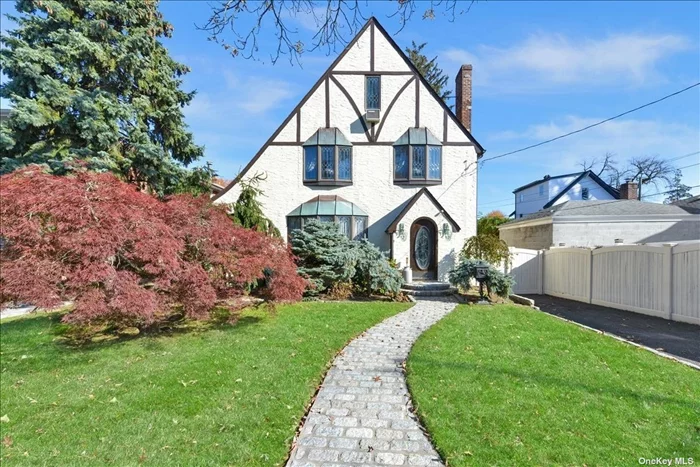 Super Unique Stucco Tudor in Prime Bayside. The First Floor Features a Huge Living Room With a Lava Rock Fireplace, Formal Dining Room, Breakfast Room, Updated Kitchen, Full Bathroom, and a Huge River Rock and Barnwood Extension with Vaulted Ceilings and Barnwood Beams. The Second Floor Has Three Oversized Bedrooms, and Another Full Bathroom, Plus a Walk Up Attic With Two More Bedrooms. Fully Finished Basement With Laundry Room, Office, Den, and Half Bathroom Perfect for Extended Families. Five Zone Gas Heat, Stained Glass and Bay Windows, Upgraded Electric, and Skylights Throughout. Conveniently Located to Parks, Shops, Schools, and Transportation.