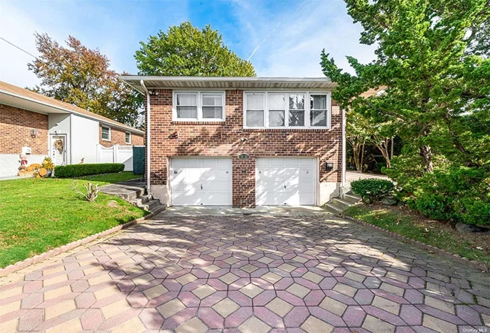 Welcome to this large Hi-Ranch home on an oversized corner lot. As you enter into the welcoming foyer, you are led a few stairs up to the elevated main level of the home, into a very spacious sunlit Living-Room, and L-shaped formal Dining Room. The kitchen has plenty of room to accommodate a breakfast nook and plans for an island at the center of the room. A vestibule gives way to the main bathroom of the house , and to the sizable bedrooms, the parental suite hosts a large bedroom adorned with a mirrored wall and an ensuite with showed stall.. The lower section is composed of a family room, a full bathroom , utility room with laundry and lastly a 2 car garage.The house has a new 2-Zone CAC System , the boiler is 2 yrs old, the hot water heater is brand new and the roof is in good condition.Conveniently located near shops, transportation, parks, schools, restaurants, and highways.