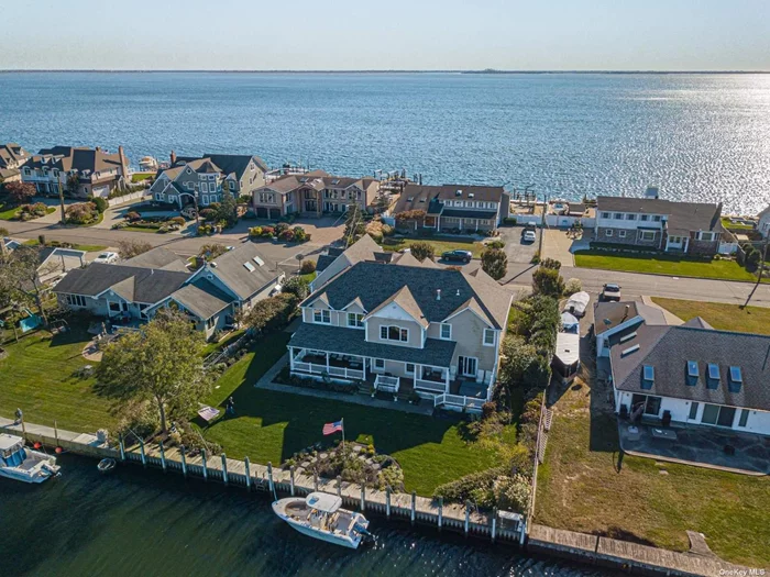 Waterfront, Paradise point, 5000 Sq Ft Magnificent Post Modern Custom Built In 2004, Cathedral Center Hall W/Custom Staircase, 5 Brs, new 4.5 Bths, Gourmet Kitchen W/17&rsquo; Center Island, Large family rm w/fplc, Butler Pantry, formal ding room, Master Suite W/Fbth, Wic & Fp, 2nd floor loft den, covered Mahogany Deck w/hot tub, 105&rsquo; Navy Bulkhead On Deep Water Canal, Dock Has Elec & Water. Brand New Roof, whole house generator, heated/ac garage, beautiful bayviews