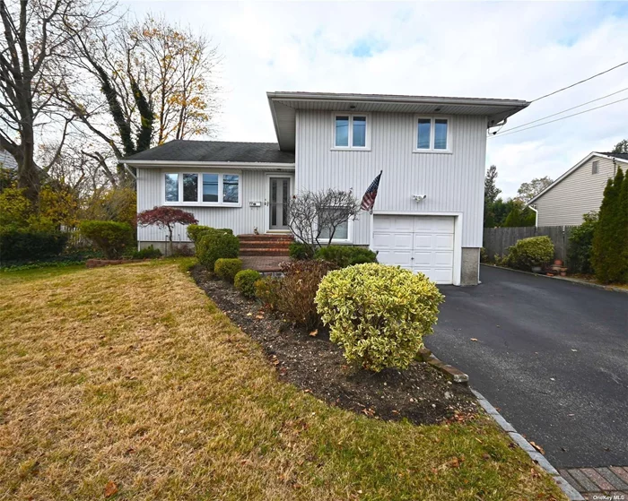 Well maintained split home in Jericho School District, Walk into an open layout - vaulted ceiling LR, granite KIT, formal dining room, addition behind dining room holds one of 2 dens, which has sliders to beautiful backyard. Up one level you have THREE Bedrooms and one Bath. Walk down three steps from main level to second Den with side door. You have access to garage through another door in the den. Half bath also has laundry room. Walk down another 3 steps to a finished basement and utility room. Oil Heating, Gas Stove! Gas in house. CAC