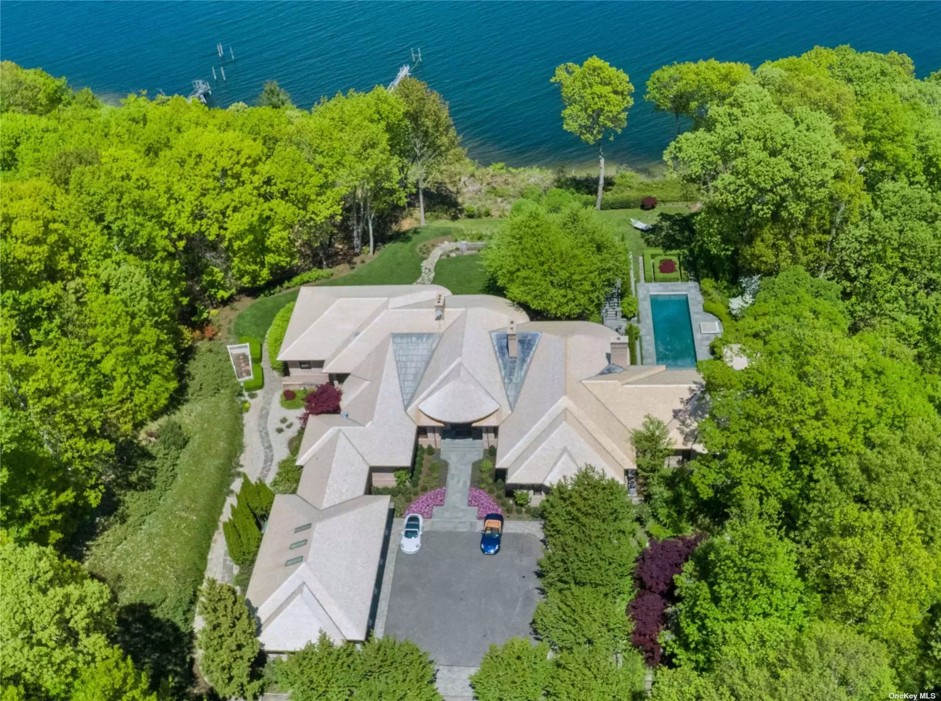 Tucked away on 7+ acres with 363 feet of waterfront property, this custom-built masterpiece by John Kean Development features exquisite craftsmanship and exceptional finishes throughout. Steps away from the original Tiffany Estate, this phenomenal residence boasts views of The Long Island Sound, Cold Spring Harbor, and Lloyd Harbor from its 90-foot covered deck. Outdoors is designed for elegant entertaining and features a pool and spa, pavilion, a tennis court, beach house, and an application has been submitted for a dock.