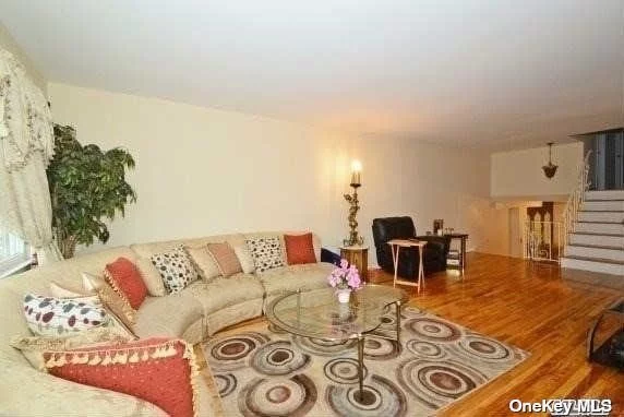 BEAUTIFUL, LARGE 4 Bedroom, 2 1/2 Bathroom, Triplex (Split-Level), Eat-in-kitchen with GRANITE COUNTERTPS, HARDWOOD FLOORS, Large Living Room, Dining Room with Lots of Windows. TOP SCHOOL DISTRICT #26. Walk-In Closet. Close to Supermarket, Banks, Restaurants, Buses Q27, QM5 (Express bus to NYC). Includes Washer, Dryer, Dishwasher, Central A/C, Garage with Private Parking. Freshly Painted. EXCELLENT CONDITION, PRIME LOCATION. MUST SEE!!!