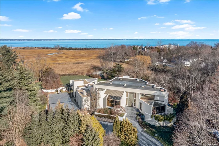 This beautiful masterpiece boasts 10, 014 square feet of ultra-luxury living, plus a finished basement and an oversized garage that can accommodate up to 8 cars. This spectacular 9 acres features a Koi pond, running brook and nature paths that lead to a tranquil private beach. This magnificent residence features 7 bedrooms including a duplex Primary suite, 8.5 baths, 3 full kitchens, 2 laundry areas, and a huge at-grade lower level with expansive guest quarters. This home also offers an amazing &rsquo;Cabana wing&rsquo; with access to the heated indoor pool/spa, & to a heated outdoor pool/spa with resort swim-up bar. This unique residence is geo-thermal powered for whole-house forced-air cooling and heat, plus radiant-heated floors throughout, multiple heated terraces with 2 outdoor kitchens & fully heated 8, 000 sq-ft driveway and heated stairs. Sands Point Country Club, Port Washington train & schools.Gut renovated & expandedSee Special Features list!