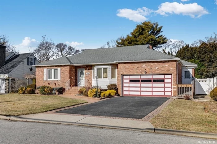 Great Location! Brick 2 bedroom 2 bathroom ranch in the heart of Seaford. Blocks from the Seaford train station and walking distance to shops and restaurants. Large open living room, dining room and beautiful sunroom with gas fireplace and electric heat. Very spacious finished basement and 2 car garage provides tons of storage.