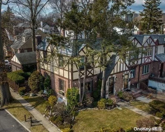 This one will not last! Sun drenched Brick semi-detached Tudor home with a detached 2 car garage. Centrally located to shopping, parks, schools, public transportation, The LIRR (22 min to NYC) and a variety of eateries along Bell Blvd! Southeast exposures fill this home with sunshine. This well kept home features Hardwood floors throughout with 3 bedrooms, 1.5 bath, Eat in kitchen, Dining room and a Finished basement. A private fenced in backyard with a patio and the front of the home features professional landscaping.