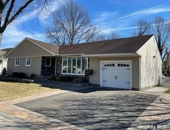 Gorgeous open concept ranch home in Syosset Woods. This property features an ample gourmet kitchen with quartz countertops and an oversized center island. Bright sun-filled rooms, a fantastic living space, generous storage space, and gleaming hardwood floors. The finished basement has been professionally detailed to allow for maximum entertainment time. Professional landscaped back and front yards with colorful blooms all year long. Trex deck and patio in the back.