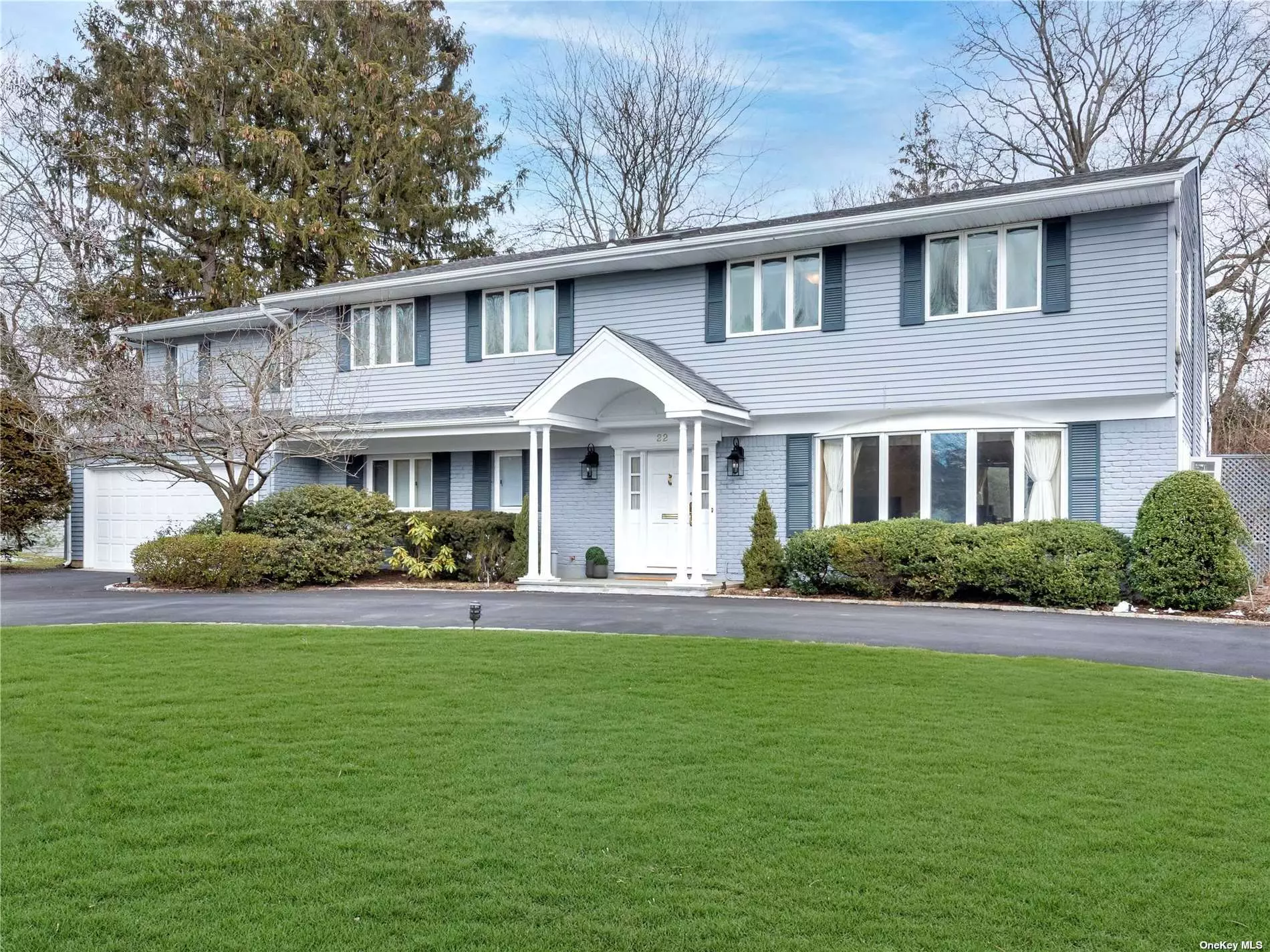 Balcony Colonial with open floor plan set on lush parklike acre+ with specimen plantings in the heart of Flower Hill. This renovated and expanded home features 5 Bedrooms and 2.5 Bathrooms. The first floor boasts gracious entry foyer, warm and inviting Family Room, oversized open Living Room/Dining Room with Fireplace, soaring ceilings and streaming sunlight. Large Eat-In Kitchen/Great Room overlooking slate patio and magnificent property. Home office/5th bedroom, powder room, laundry and attached heated 2-car garage. Second floor has enormous Primary Bedroom and Bath plus three additional Bedrooms and new hall Bath. Basement with rec room, utilities and storage room. Whole house generator, gas heat, circular driveway. Close to Flower Hill Park, LIRR, shopping and major highways. Port Washington Schools.