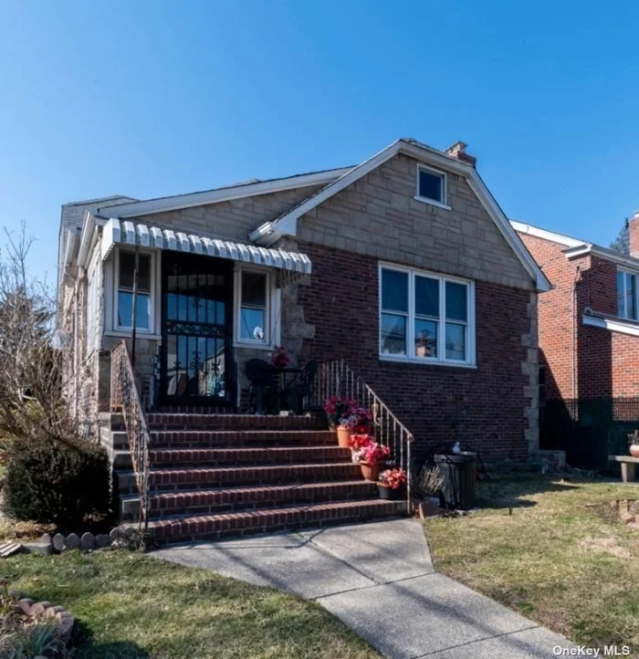 Spacious sunny Tudor Cape on corner lot with 2, 338 sq feet of living space. Enclosed front porch, 1st Fl: Eat In Kitchen, Large LR with 9 Ft. beamed cathedral ceiling, stained glass windows on both sides of field stone fireplace, huge formal dining room, full bath with separate shower, 2 bedrooms. 2nd fl: 2 large bedrooms & large closets, storage. Basement partially finished with high ceilings. House needs work, but has great Tudor details and lots of charm. Truly a diamond in the rough in a great location, steps to Q15 & Q16 bus to downtown Flushing, 3 blocks to Bowne Park & close to Broadway station of LIRR. Detached garage with large fenced-in yard with covered patio.