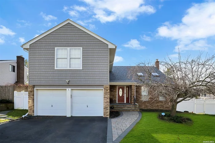 Curb appeal for days on this oversized property w/heated, salt-water inground pool. Brand new stoop w/Cambridge pavingstones to enter the home. Step down to LR w/stone fireplace, 2 sky lights + cathedral ceiling. FDR. Updated EIK w/pantry. Fam rm. Laundry + powder rm. Access from inside to a 2 car-garage. 4 extremely spacious brs w/all new hardwood flrs upstairs. MBR has open en-suite. Finished basement w/custom closet, wet bar+ wine fridge. Brand new retaining wall + retractable awning. Inground sprinklers. Central AC. Roof + siding 3 yrs young. Whole house water pressure pump to boost water pressure throughout home. Tesla solar panels are fully owned keeping your electric bills low. Access to 2 private beaches. Txes w/ STAR: $12, 122.60